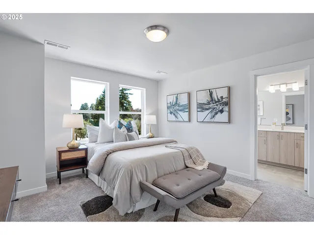 a bedroom with a bed and painting on the wall