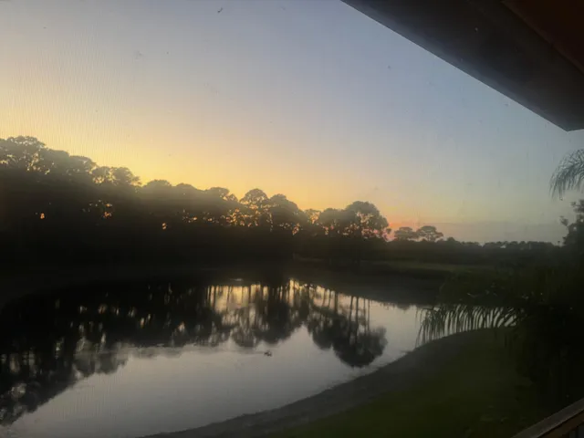 a room with a chair and a flat screen tv