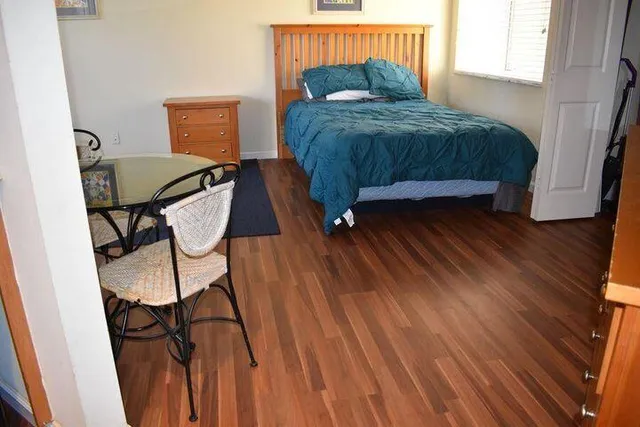 a room with a window and a dresser