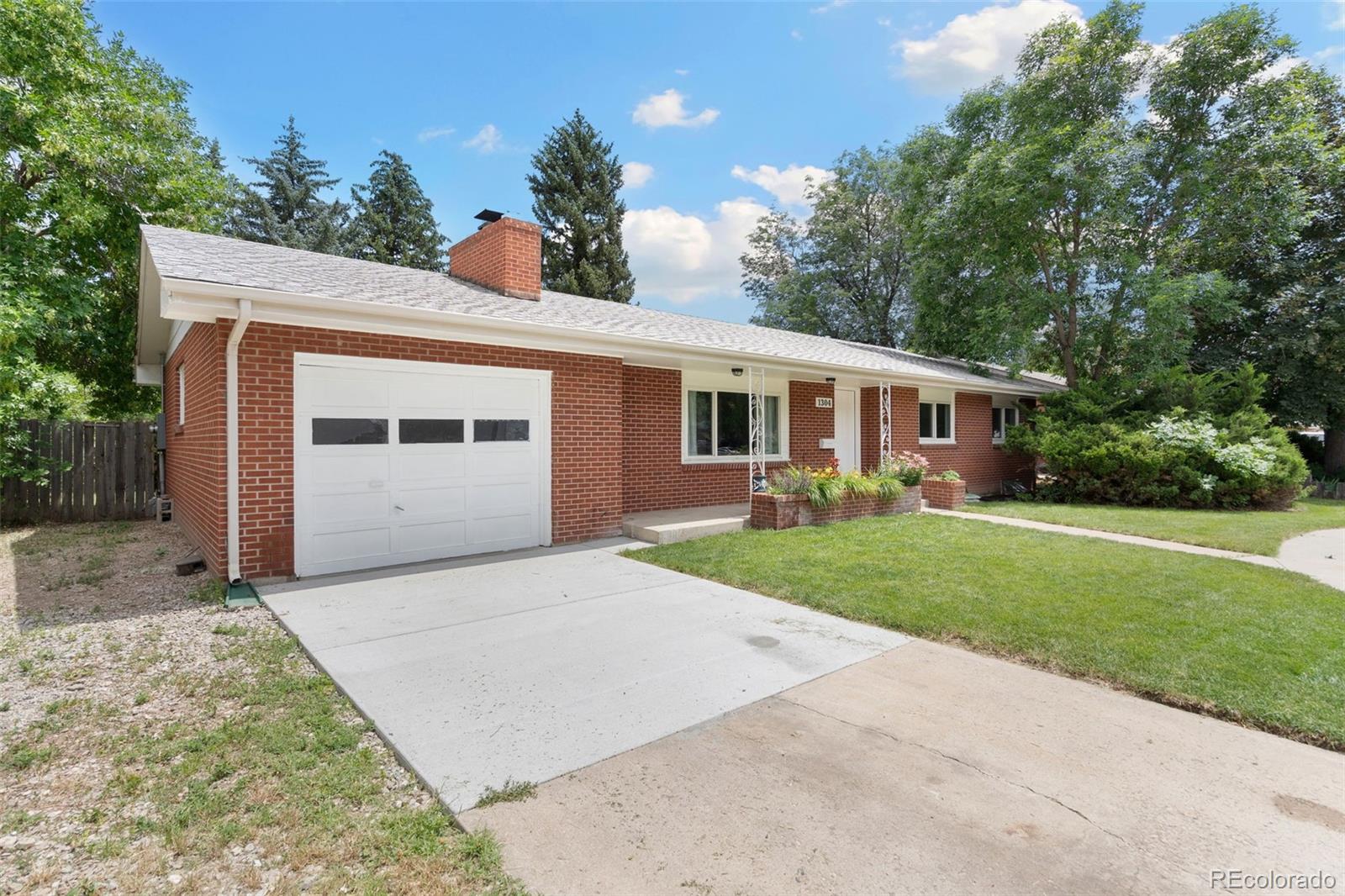 1304 South Lemay Avenue Fort Collins, CO 80524 - Photo 2 of 21 a front view of a house with a yard and garage