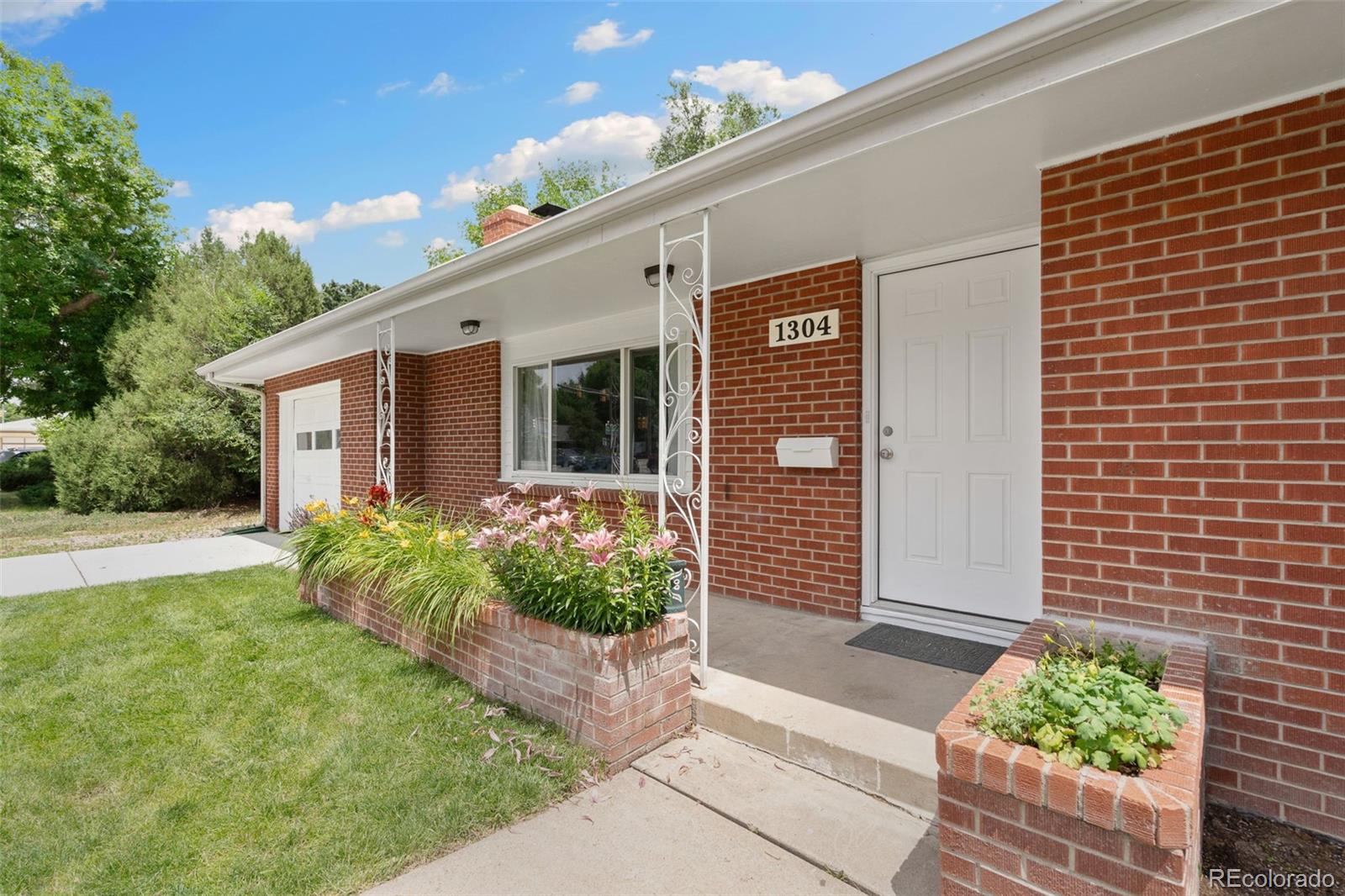 1304 South Lemay Avenue Fort Collins, CO 80524 - Photo 3 of 21 a front view of a house with garden