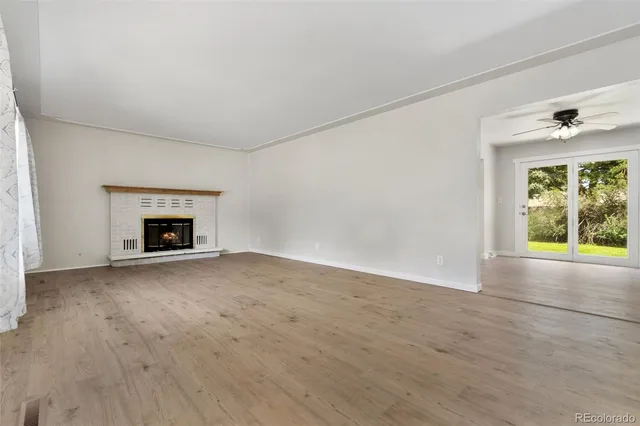 wooden floor fireplace and natural light in room