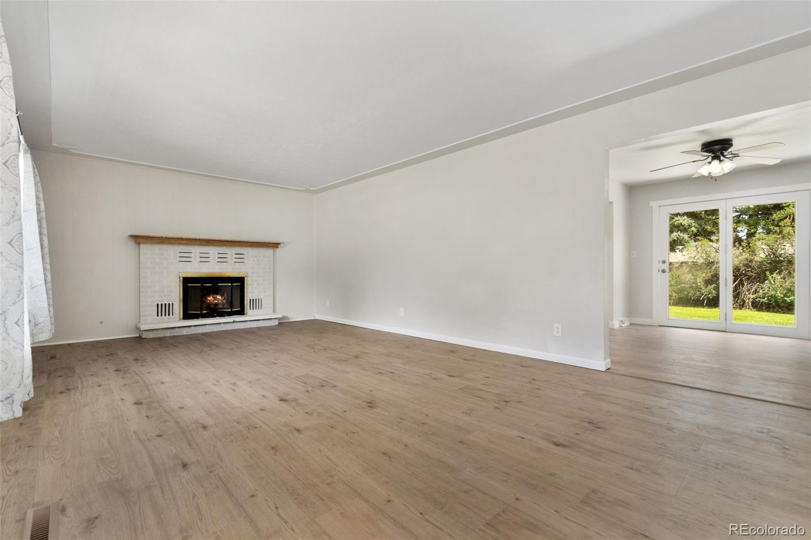 1304 South Lemay Avenue Fort Collins, CO 80524 - Photo 4 of 21 wooden floor fireplace and natural light in room