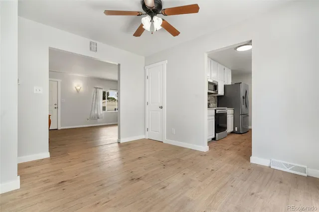 a view of a kitchen with a sink and a refrigerator