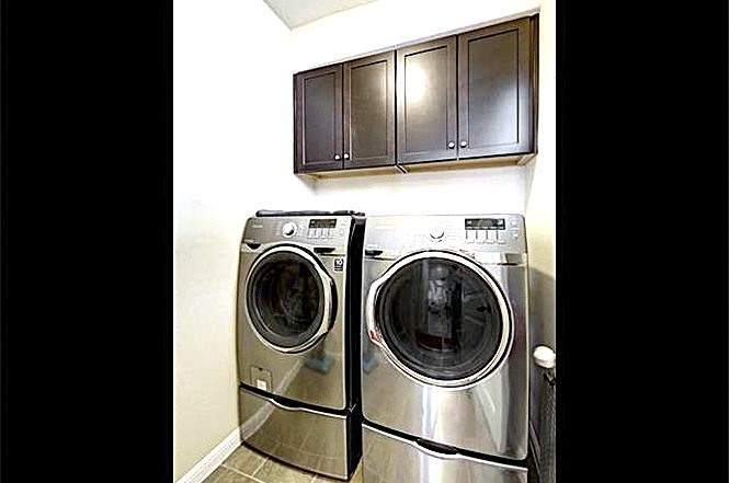 14001 Avery Ranch Boulevard, Unit 801 Austin, TX 78717 - Photo 17 of 26 Functional laundry space featuring modern appliances and convenient overhead cabinetry.