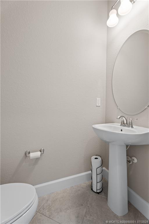 1857 Southeast Tarni Way Stuart, FL 34996 - Photo 11 of 21 a bathroom with a sink and mirror
