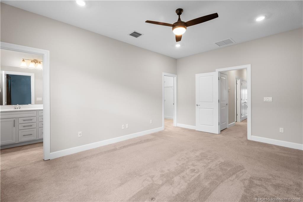 1857 Southeast Tarni Way Stuart, FL 34996 - Photo 19 of 21 an empty room with closet and a chandelier fan