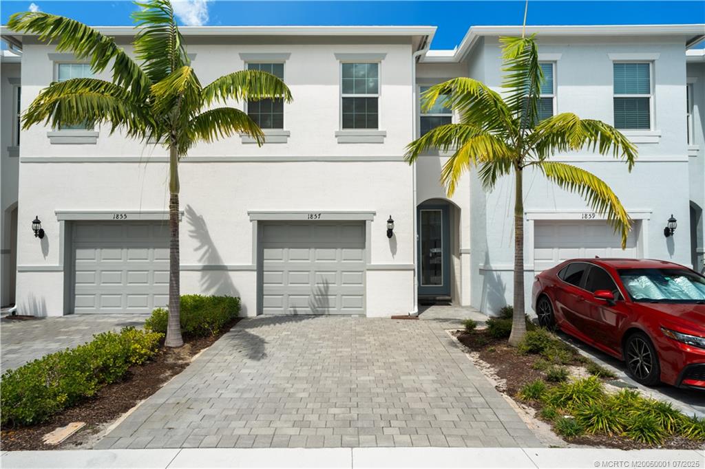 1857 Southeast Tarni Way Stuart, FL 34996 - Photo 2 of 21 a front view of a house with a yard