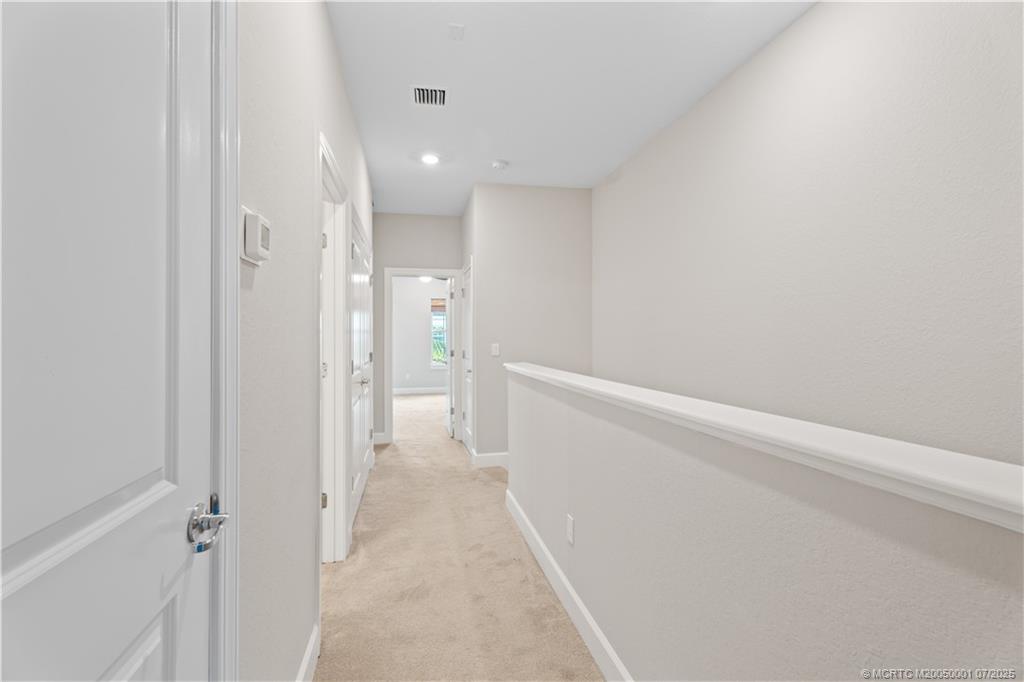 1857 Southeast Tarni Way Stuart, FL 34996 - Photo 21 of 21 a view of a hallway with wooden floor