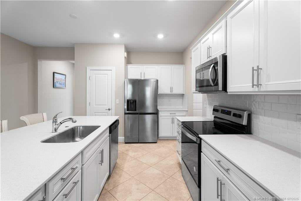 1857 Southeast Tarni Way Stuart, FL 34996 - Photo 8 of 21 a kitchen with a sink stove and refrigerator