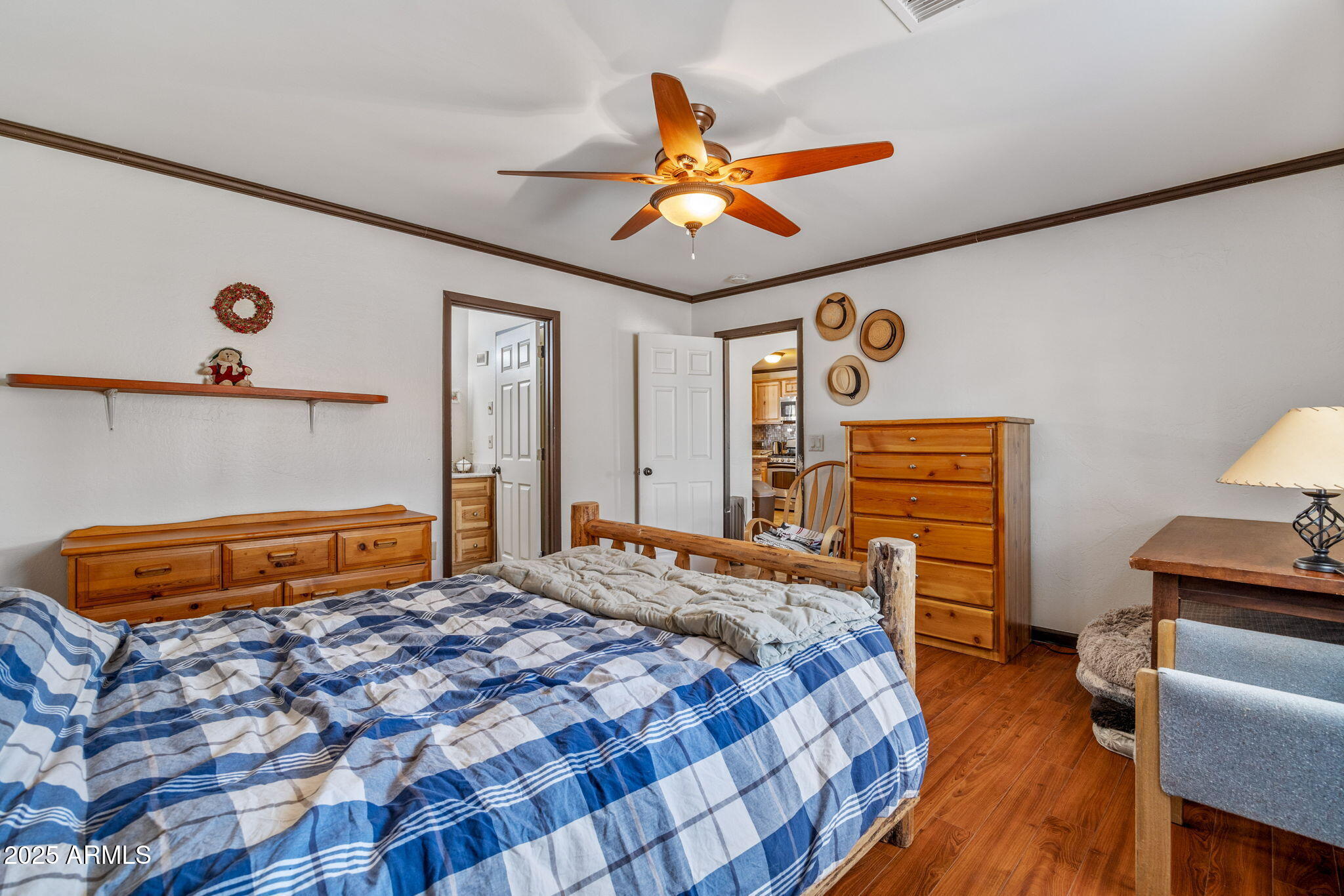 2727 Pine Meadow Drive Overgaard, AZ 85933 - Photo 15 of 34 a bedroom with a bed and a chandelier