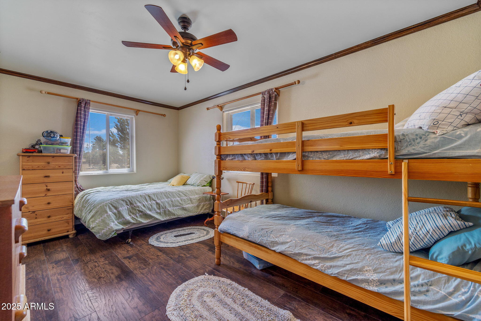 2727 Pine Meadow Drive Overgaard, AZ 85933 - Photo 17 of 34 a bedroom with a bed and wooden floor