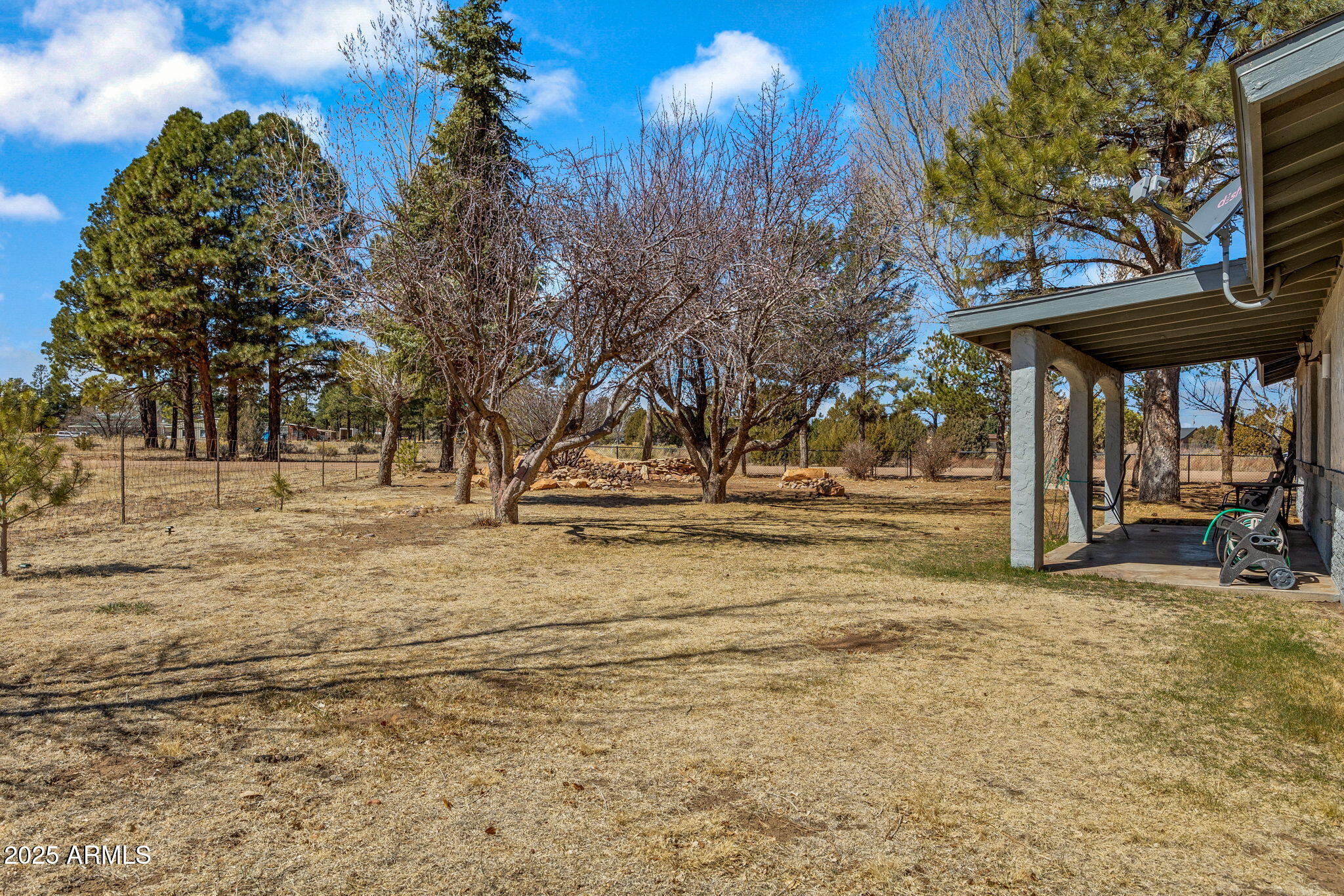 2727 Pine Meadow Drive Overgaard, AZ 85933 - Photo 27 of 34 a view of a playground with a house and trees