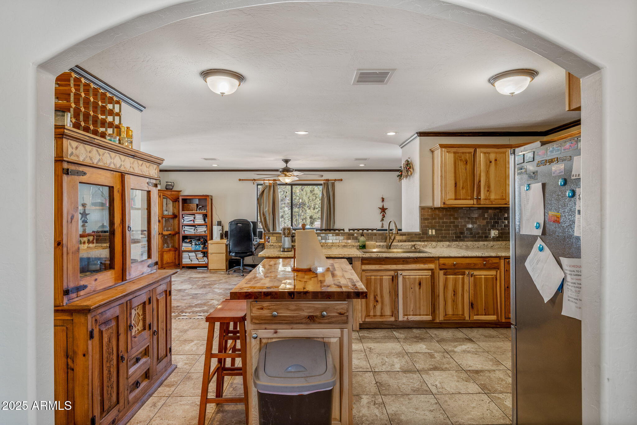 2727 Pine Meadow Drive Overgaard, AZ 85933 - Photo 8 of 34 a kitchen with stainless steel appliances granite countertop a stove top oven a sink a dining table and chairs