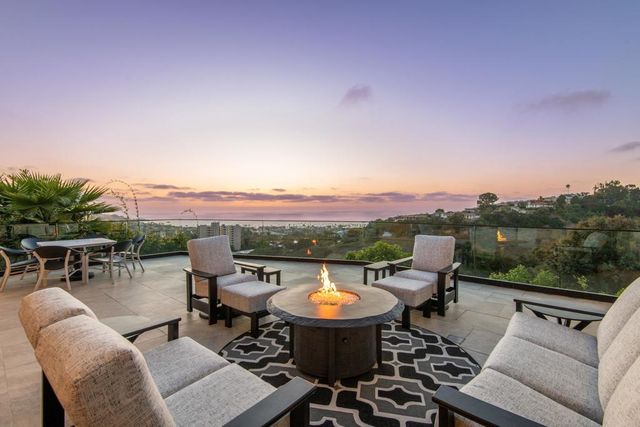 a view of a chairs and table in patio