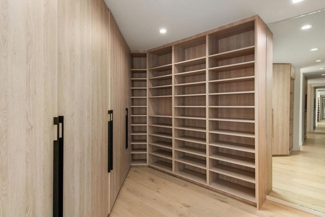 a view of an empty room with empty shelves