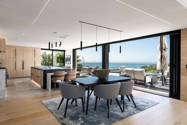 a dining room with furniture and a large window