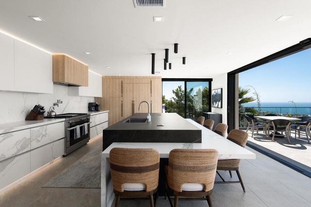 a kitchen with a table chairs sink and cabinets