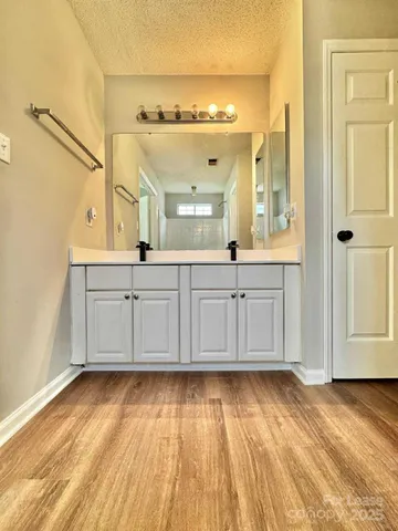 a view of a kitchen with wooden floor and cabinets