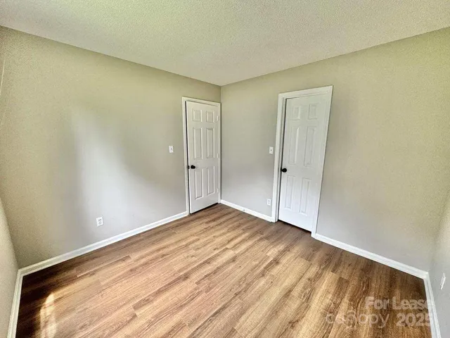 a view of an empty room and wooden floor