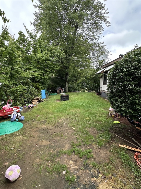 1 Independence Lane Warren, MA 01585 - Photo 16 of 16 a view of a backyard with a garden and entertaining space