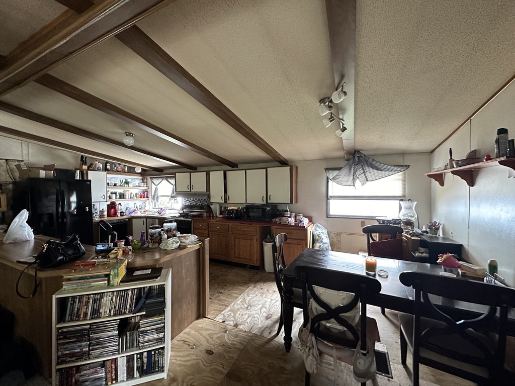 1 Independence Lane Warren, MA 01585 - Photo 7 of 16 a kitchen with a stove a table and chairs in it