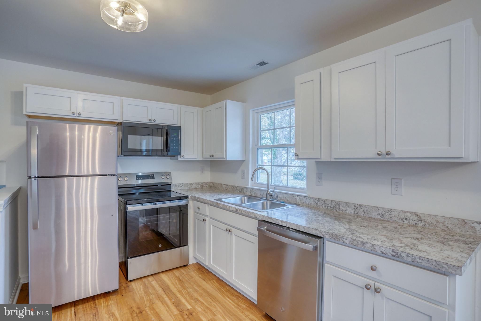 811 Sunset Terrace Dover, DE 19904 - Photo 15 of 45 a kitchen with stainless steel appliances granite countertop a refrigerator sink and cabinets