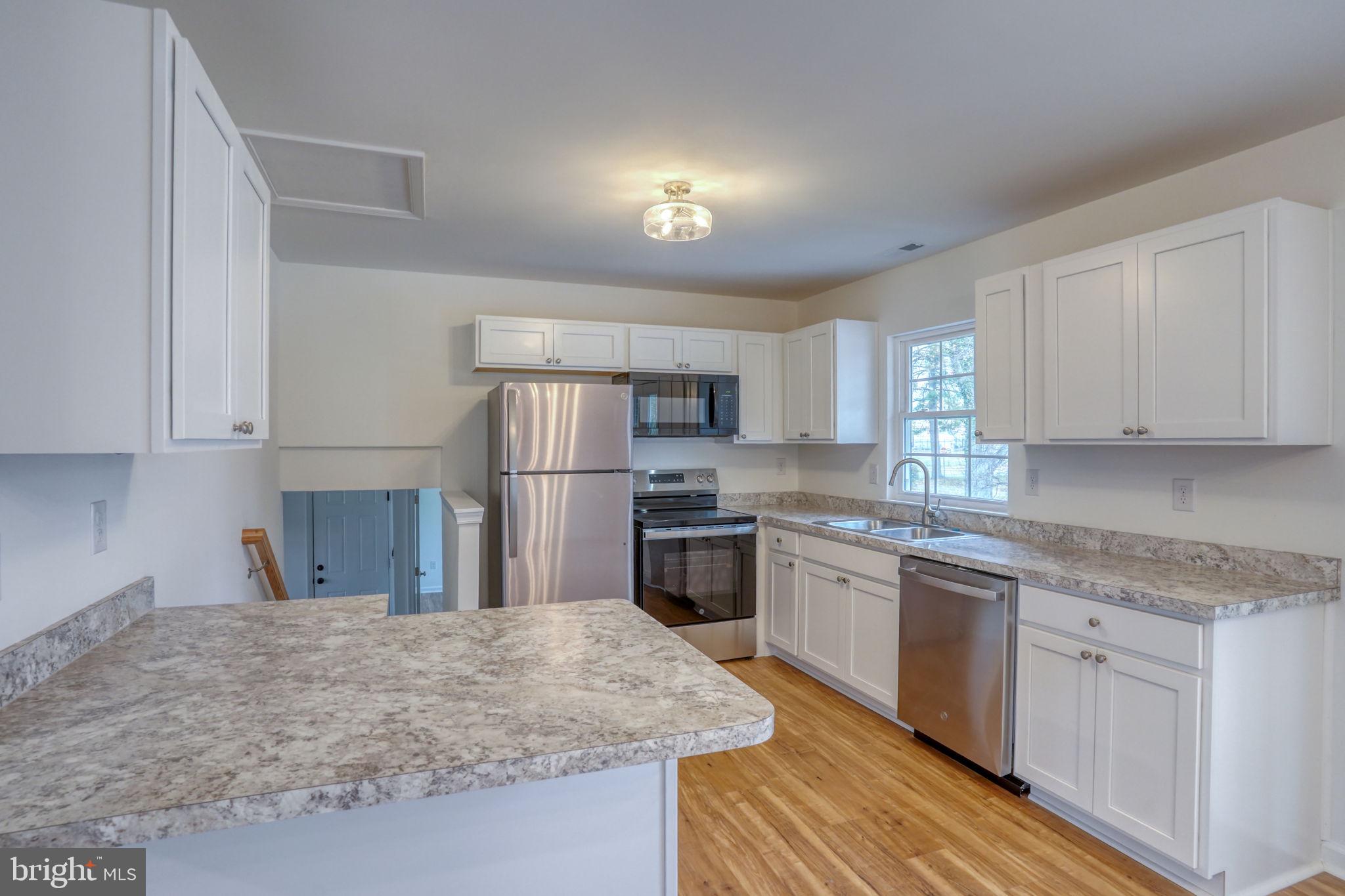 811 Sunset Terrace Dover, DE 19904 - Photo 16 of 45 a kitchen with stainless steel appliances granite countertop a sink stove refrigerator and cabinets