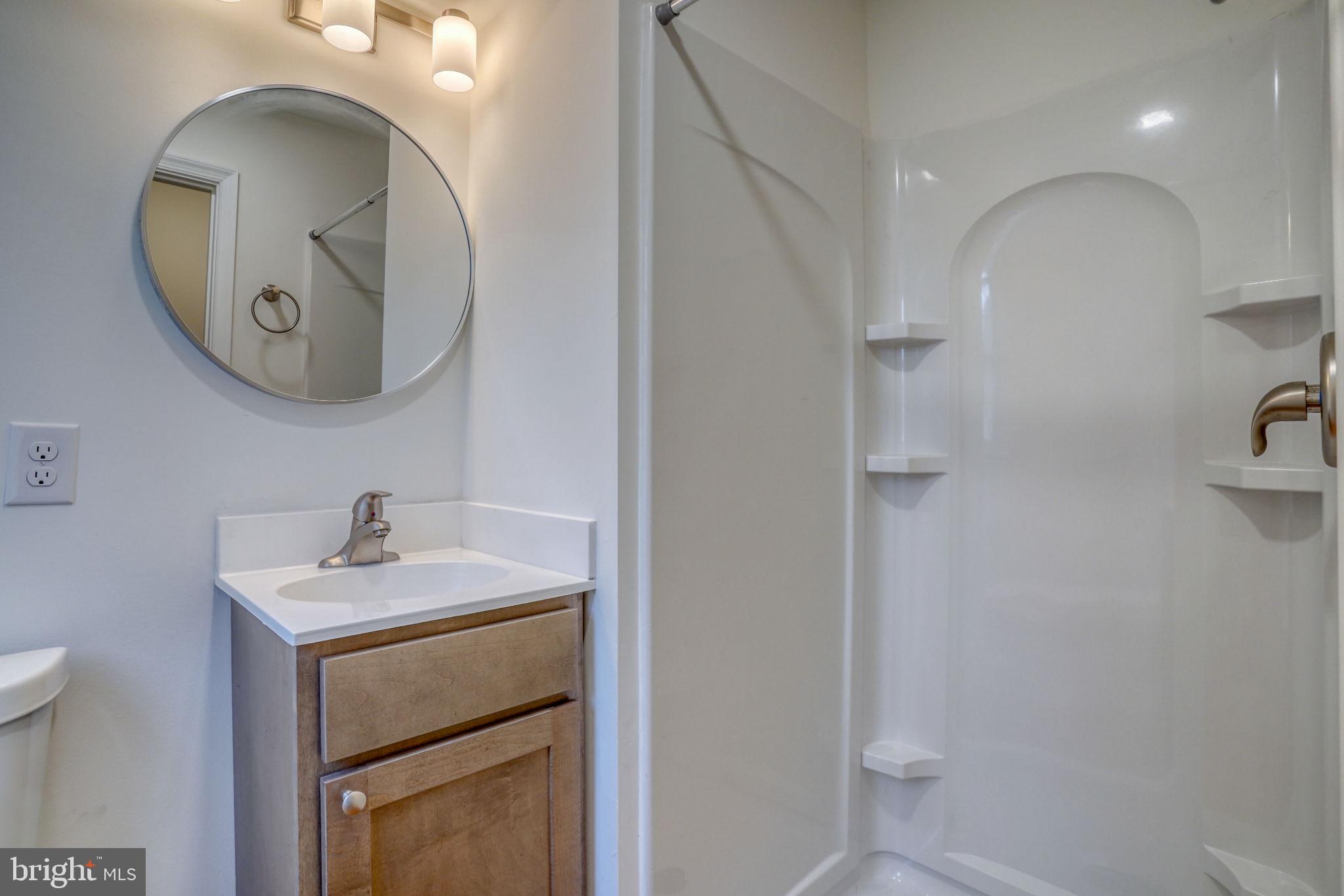 811 Sunset Terrace Dover, DE 19904 - Photo 18 of 45 a bathroom with a sink a toilet and a mirror