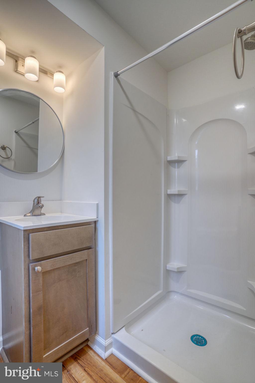 811 Sunset Terrace Dover, DE 19904 - Photo 19 of 45 a bathroom with a shower sink vanity and a mirror