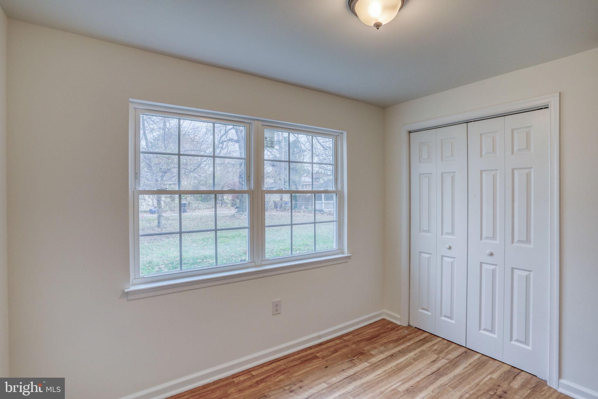 811 Sunset Terrace Dover, DE 19904 - Photo 23 of 45 a view of an empty room with wooden floor and a window