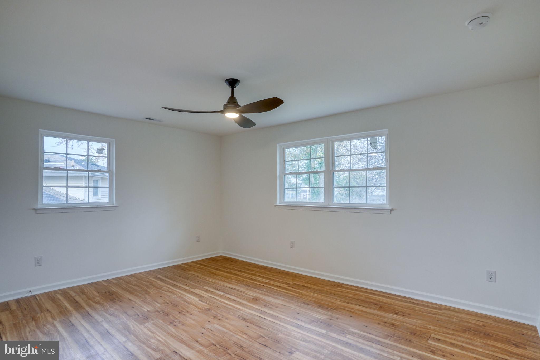 811 Sunset Terrace Dover, DE 19904 - Photo 34 of 45 a view of empty room with wooden floor and fan