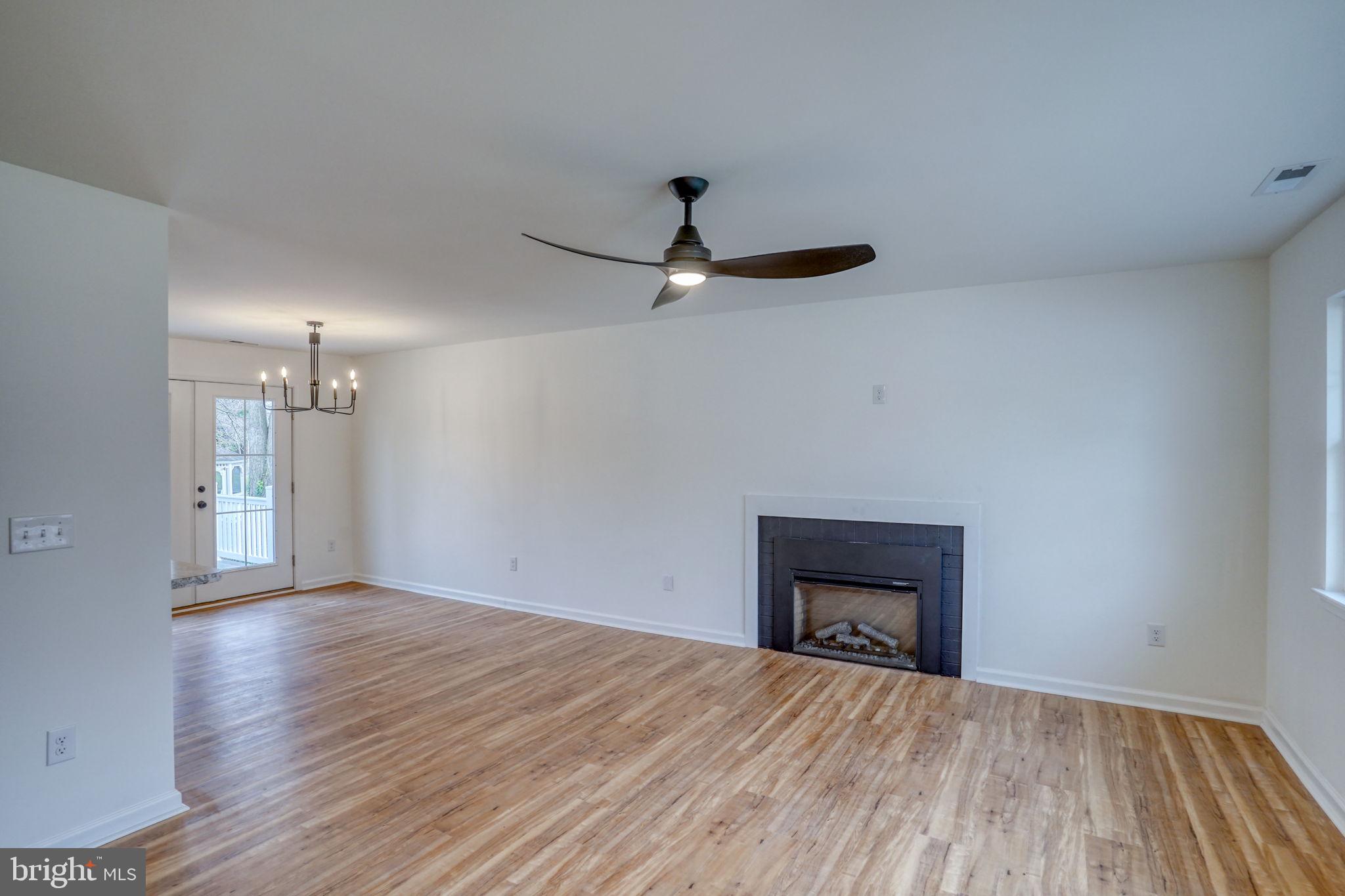 811 Sunset Terrace Dover, DE 19904 - Photo 6 of 45 a view of an empty room with wooden floor and a ceiling fan
