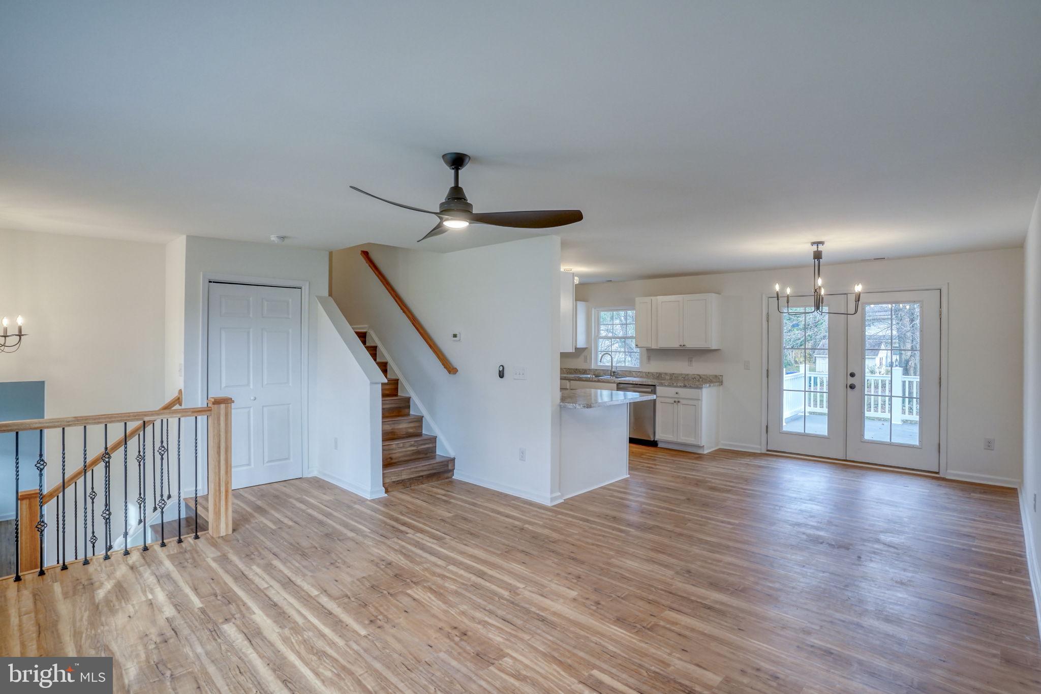 811 Sunset Terrace Dover, DE 19904 - Photo 9 of 45 a view of empty room with wooden floor and stairs