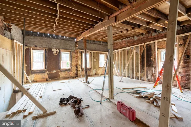 a view of a livingroom with couch and wooden floor