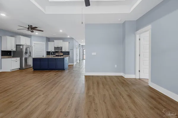 a view of kitchen with cabinets and wooden floor