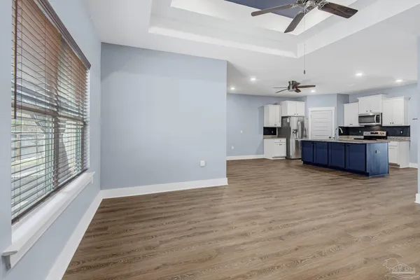 a view of kitchen with furniture and wooden floor