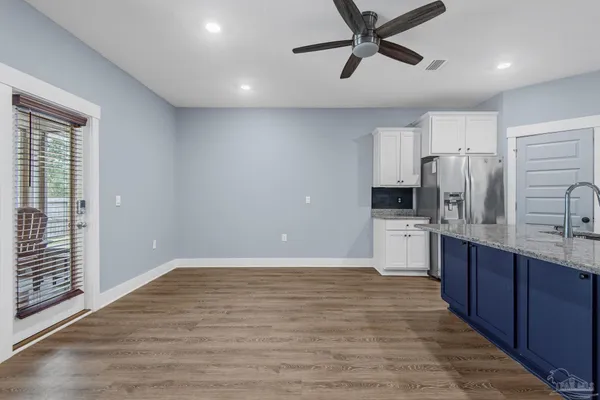 a kitchen with stainless steel appliances a refrigerator sink and cabinets