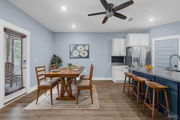 a view of a dining room with furniture and a window