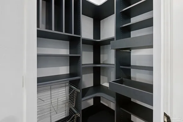 a view of walk in closet with empty racks