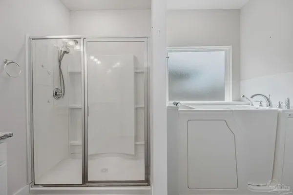 a bathroom with a shower sink and mirror