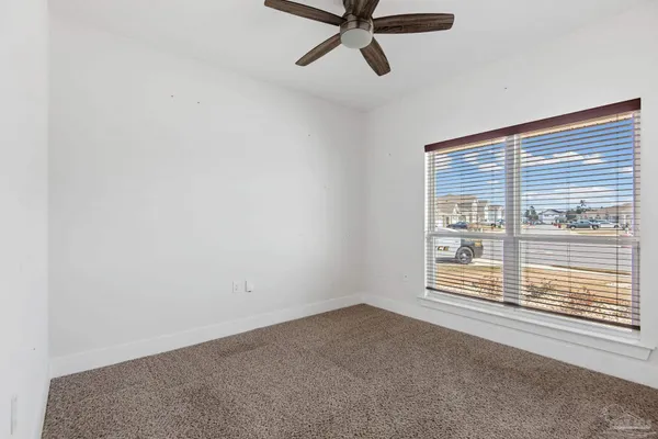 a view of a room with a window and a ceiling fan