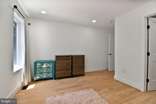 an empty room with windows and closet
