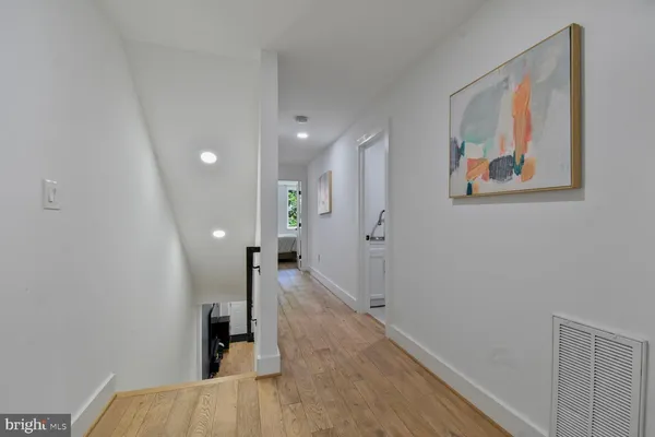 a view of hallway with wooden floor