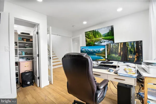 a view of a workspace with furniture and a backyard