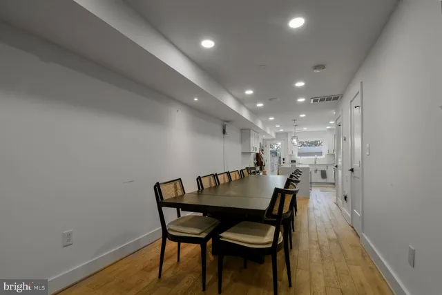 a dining room with furniture and wooden floor