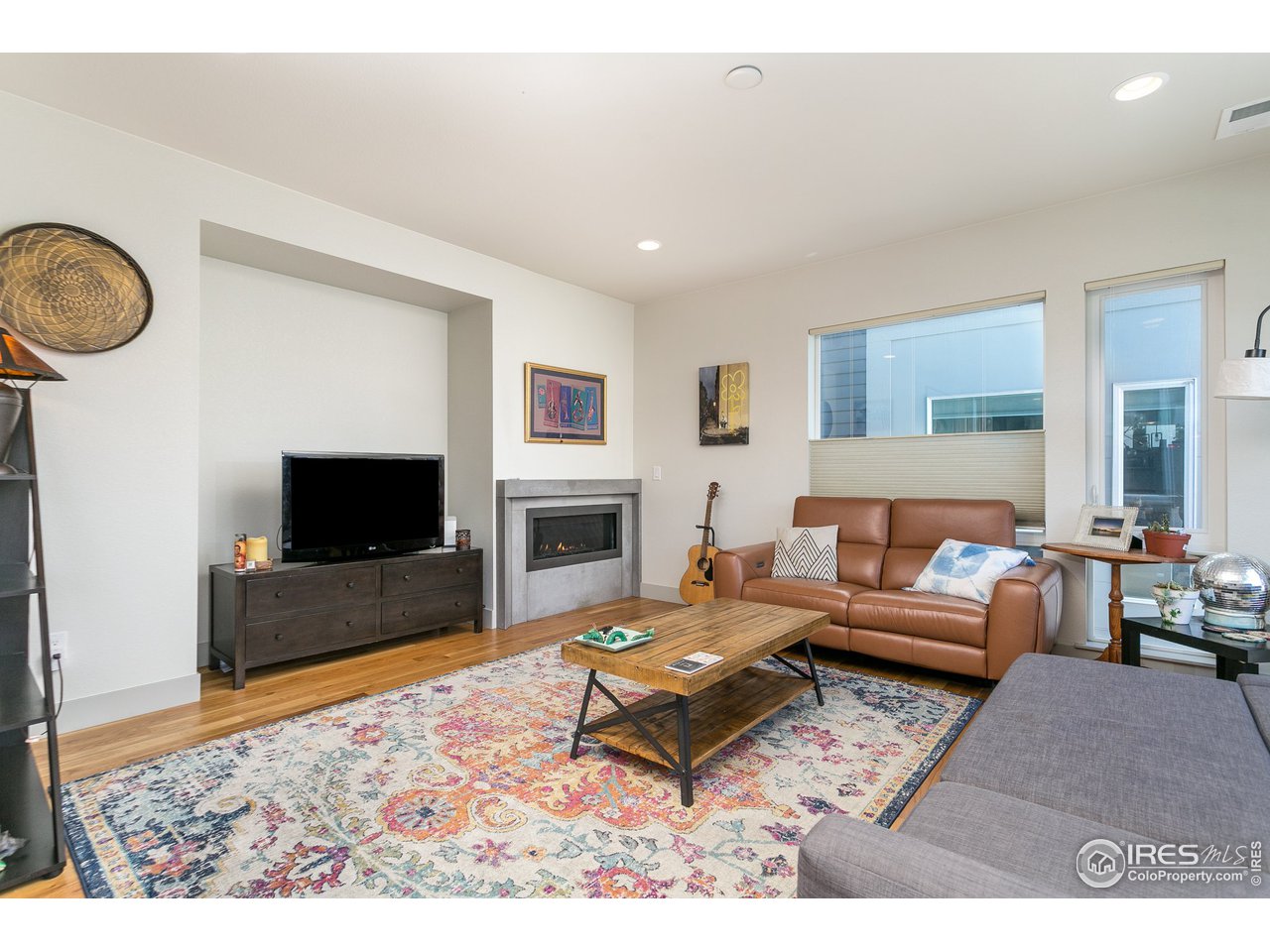 1925 Hooker Street Denver, CO 80204 - Photo 15 of 31 a living room with furniture a flat screen tv and a fireplace