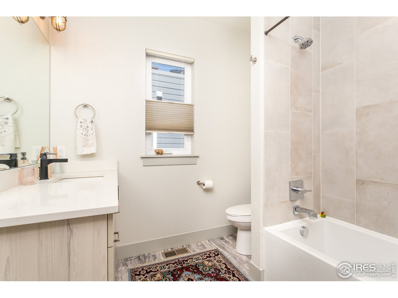 1925 Hooker Street Denver, CO 80204 - Photo 22 of 31 a bathroom with a sink a toilet and a mirror