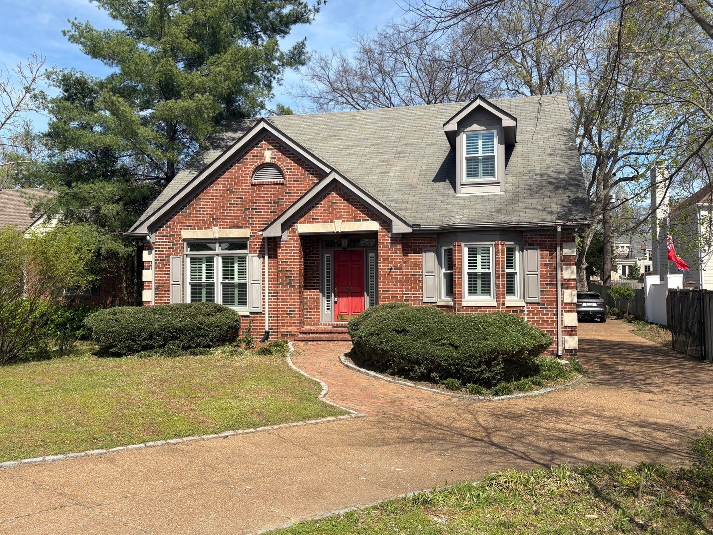 a front view of a house with a garden