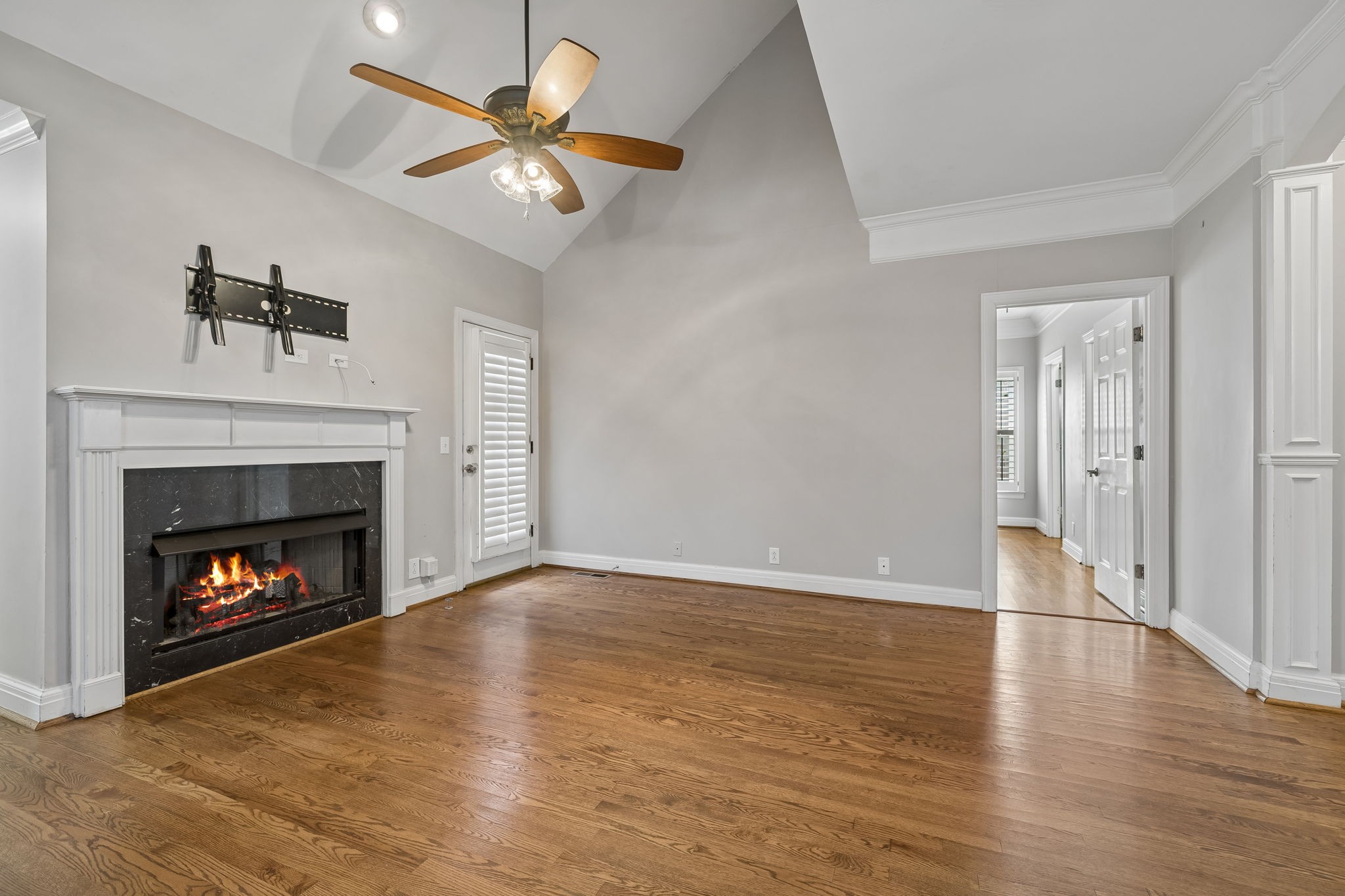 230 Harding Place Nashville, TN 37205 - Photo 14 of 54 a view of an empty room with wooden floor fireplace and a window